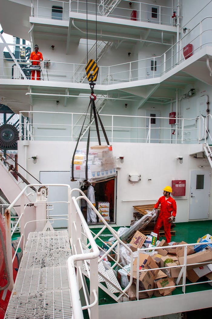 service-01 Cargo and maritime workers handling supply transfer on a ship deck.