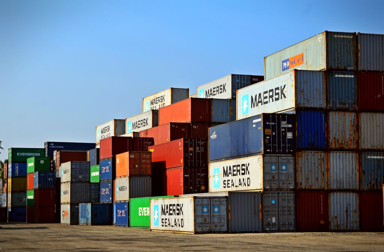 service-03 Colorful stacked shipping containers at a port exemplify global logistics.